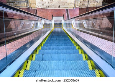 Looking Down At Multiple Escalators Outside Building