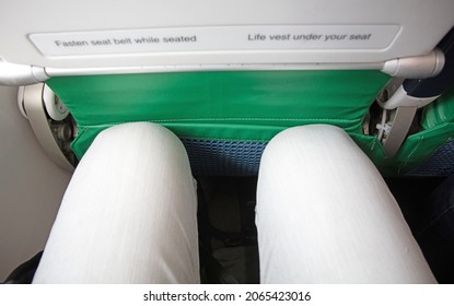 Looking Down At Narrow Leg Space In Low Cost Airline Seat, Knees Touching Back Rest At Front, Selective Focus