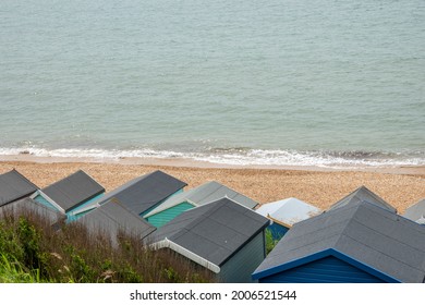 looking down on beach huts on the sea shore from above	
