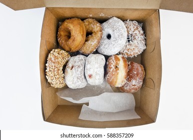 Looking down on a box full of disgustingly delicious doughnuts. Isolated.