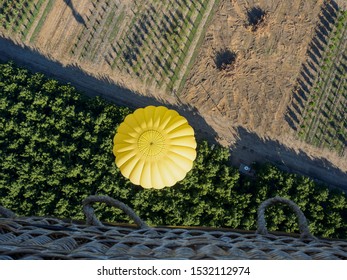 Looking Down On Hot Air Ballon And Farm Crops Below