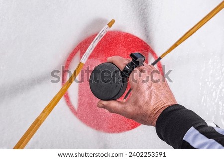 Looking down on a referee dropping puck in the faceoff circle