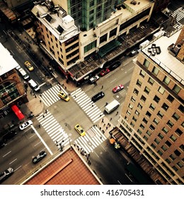 Looking Down On To The Streets Of New York City With New York Yellow Taxis And People Crossing The Street Going To Work. Instagram Style Image.