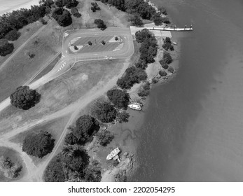 Looking Down Onto The Car Park And Boat Ramp At Grasstree Beach Queensland Australia At Low Tide. Two Boats Moored On The Banks.