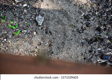 Looking Down From Out Of Focus Bridge Rail  To Perhaps A Bigfoot Track