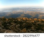 Looking down over Hobart from Mount Wellington, Tasmania, with the city spreading across the landscape beneath the rugged slopes of Kunanyi and the surrounding wilderness.
