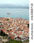 Looking down over Nafplio and its harbor (harbour) with Bourtzi Castle. Nafplio is an old town in Peloponnese Greece with historic roots. Nafplio is also known as Nafplion, Nauplio and Nauplion.