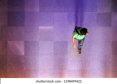 Looking Down At Silhouette Of Business Man, Traveler Walking On The Marble Brick Floor. Top View, Space For Type