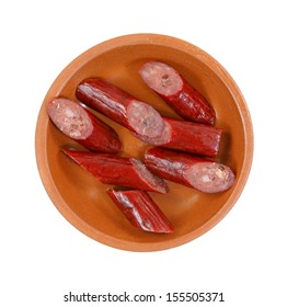 Looking Down At A Sliced Beef Stick In A Ceramic Dish.