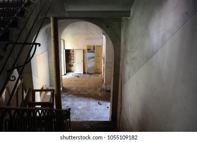 Looking Down At Stair Foyer In An Abandoned Psychiatric Hospital Building In Italy