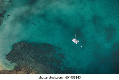 Looking Down Upon A Boat Float In Shallow Water