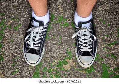 Looking down wearing casual shoes