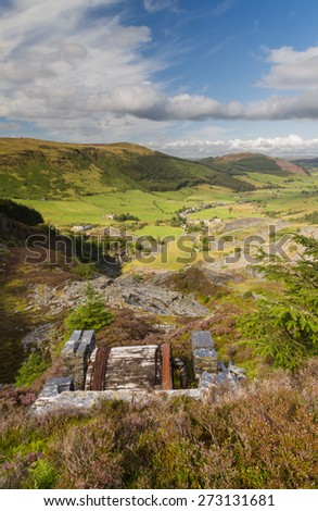 Looking down the welsh valley of Cwm Penmachno, derelict incline drum house  disused slate quarry in foreground. Snowdonia, Wales, United Kingdom