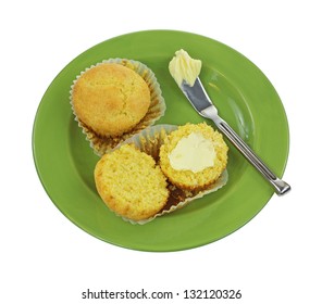 Looking Down At A Whole And Split Buttered Corn Muffin On Plate.