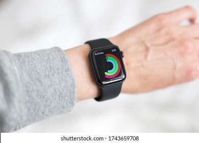 Looking Down At Woman's Hand Wrist Wearing Black Apple Watch A Health Fitness Watch Tracker To Monitor Heart Rate, Activity Levels, Execise Fitness Movement. Keeps You Fit And Motivated. Modern 