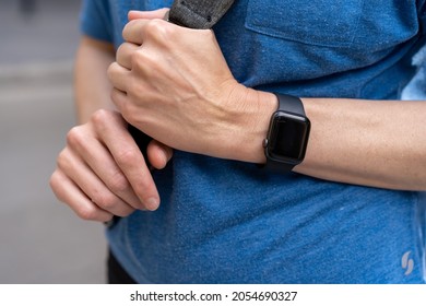 Looking Down At Woman's Hand Wrist Wearing Black Apple Watch