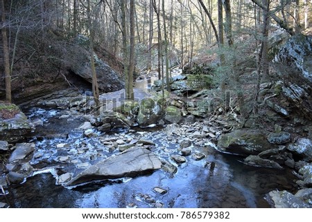Looking downstream from the falls along Fall Creek, ice begins to accumulate during an artic winter storm at the Ozone Falls State Nature Area in Cumberland County, Tennessee.