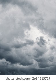 Looking up at the dramatic sky with storm clouds. Sky gradient from light grey to dark steel grey.