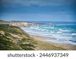 Looking east along Portsea Beach on the Bass Strait side of the Mornington Peninsula, Victoria as the south westerly winds from the Southern Ocean drive the waves to the shoreline.