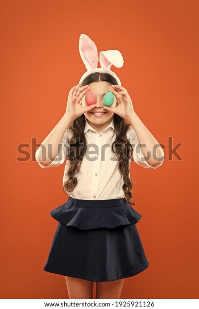 looking for eggs. happy child hold painted egg.\
have fun on spring holiday. schoolgirl in rabbit ears. Easter eggs\
and cute bunny. happy easter. small girl wearing bunny ears. kid on\
easter egg hunt.