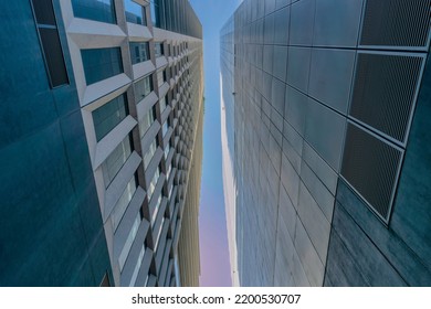 Looking Up At The Exterior Of Modern Buildings And Blue Sky From A Back Alley. Apartments Or Offices In Austin Texas Viewed From The Passage Way Between Buildings.