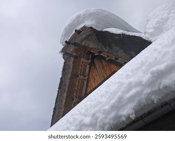 Looking up to Gassho-zukuri traditional japanese thatched roof house with big snowdrifts