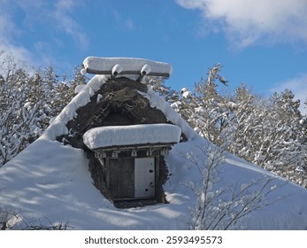 Looking up to Gassho-zukuri traditional japanese thatched roof house with big snowdrifts