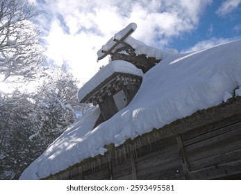 Looking up to Gassho-zukuri traditional japanese thatched roof house with big snowdrifts