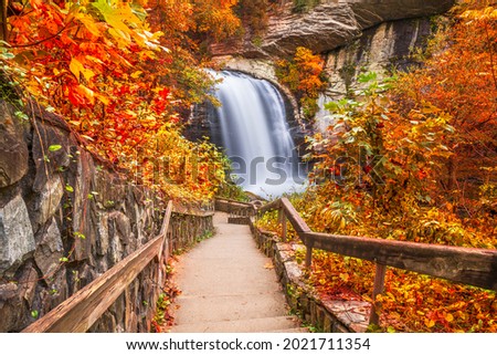 Looking Glass Falls in Pisgah National Forest, North Carolina, USA with early autumn foliage.