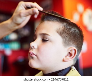 Looking Good. Closeup Shot Of A Young Boy Getting A Haircut At A Barber Shop.