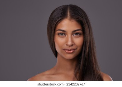 Looking gorgeous yet natural. Portrait of a beautiful young woman posing in the studio.