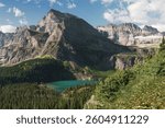 Looking from Grinnell Glacier Trail over Grinnell Lake at the surrounding mountain range including Mount Gould in Swiftcurrent, Montana, USA