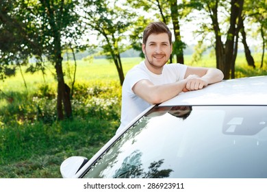 Looking Happy. Youthful  Attractive Man With Beard Leaning On Roof Of His Car And Smiling.