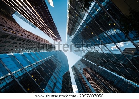 Looking up at high rise office building architecture against blue sky in the financial district of Toronto in Ontario, Canada, business and finance concept.