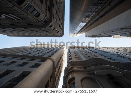Looking up at the historic Edificio Martinelli and modern office towers against a clear sky in the center of Sao Paulo, Brazil, urban architecture