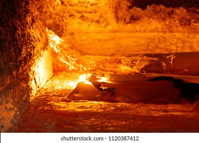 Looking Inside An Aluminum Melting Furnace, In A Foundry, With Liquid And Solid Pieces Of Metal