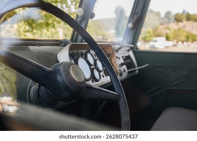 Looking inside the cabin of a simple old military transport van, bare interiors, rugged vehicle