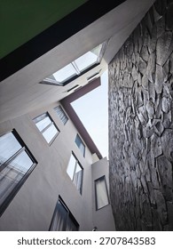 looking up into an architectural space, possibly an inner courtyard or light hole.