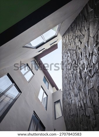 looking up into an architectural space, possibly an inner courtyard or light hole.