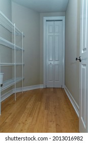 Looking Into An Empty Storage Closet With Doors.