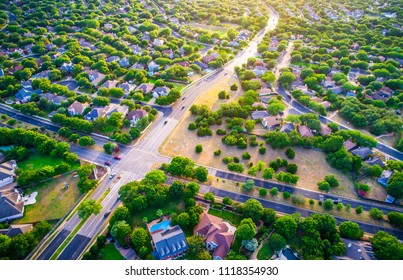 Looking Into Golden Sunset Modern Homes And Houses In Suburb. High Aerial View Above Thousands Of Homes North Of Austin , Texas In Round Rock Suburbia Sunset Colors Of New Development Neighborhood