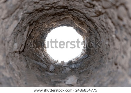 Looking into the unknown through a stone tunnel