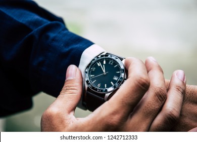 Looking At Luxury Watch On Hand Check The Time Writing Business Information In Notepad At Workplace.concept For Managing Time Organization Working,punctuality,appointment.fashionable Wearing Stylish