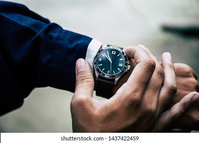 looking at luxury watch on hand check the time.concept for managing time organization working,punctuality,appointment.fashionable wearing stylish - Powered by Shutterstock