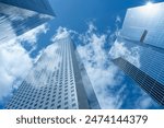 Looking Up  modern high-rise office buildings with blue sky in the background. 