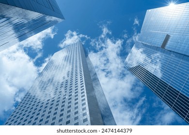 Looking Up  modern high-rise office buildings with blue sky in the background. 