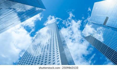 Looking Up  modern high-rise office buildings with blue sky in the background.  - Powered by Shutterstock