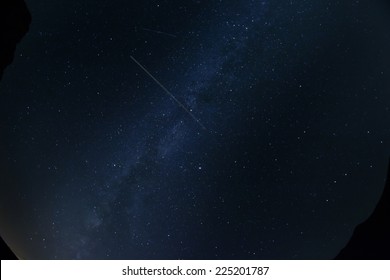 Looking up at the night sky and airplane trail - Powered by Shutterstock