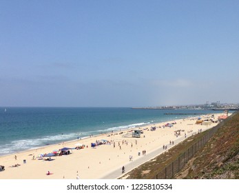 Looking North Over The Beach In Redondo Beach Near Los Angeles On A Sunny Summer Day With A Lifeguard Tower And Beach Volleyball Court In View.