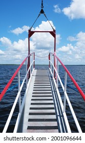 Looking Off A Boat Straight Out The Gang Plank At The Water And Blue Cloudy Sky